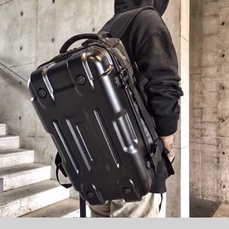 Lifestyle scene of a person wearing the Roadforge Hardcase Backpack in Night Black with a rugged, matte finish.